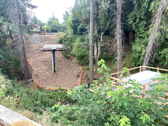 Looking south towards SW Capitol Highway from the Red Electric Bridge construction site with bridge pillars in view.