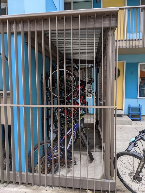 A bike cage built for a Hacienda CDC community with a tall metal gate that keeps bikes safe. 