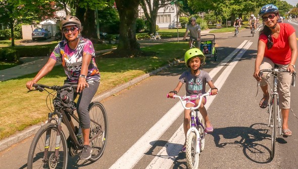Two women and a child bike together at a past North Portland Sunday Parkways event.