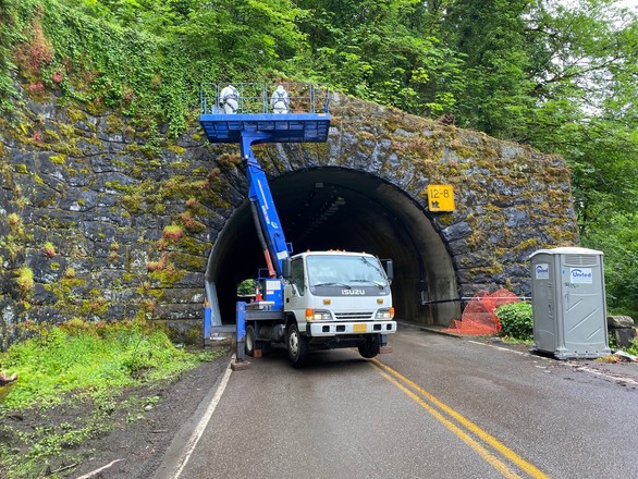 Photo of crews from the Portland Bureau of Transportation cleaning the stone masonry portal of one of the Cornell Tunnels. Photo by PBOT