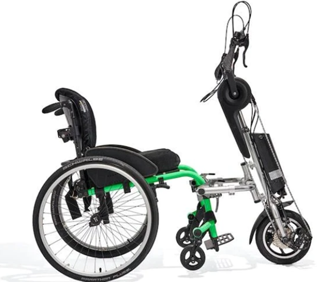The eDragonfly is an upright handcycle that is attached to a manual wheelchair, a small wheel in the font is the steering mechanism.