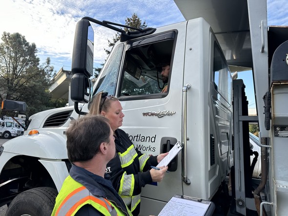 A snowplow being inspected during a winter weather prep event