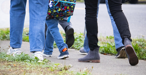 Close up image of parents and kids walking to school on a sidewalk. PBOT Safe Routes to School has resources to help.