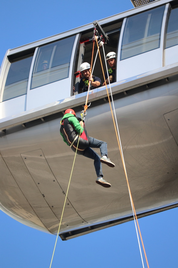 Firefighters monitor a tram operator who participates in the evacuation drill
