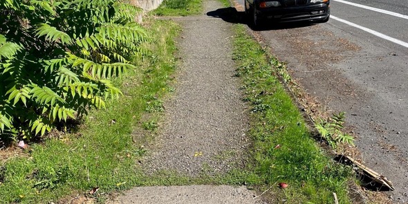 A gravel goat path in the Brentwood-Darlington neighborhood will soon become a concrete sidewalk.