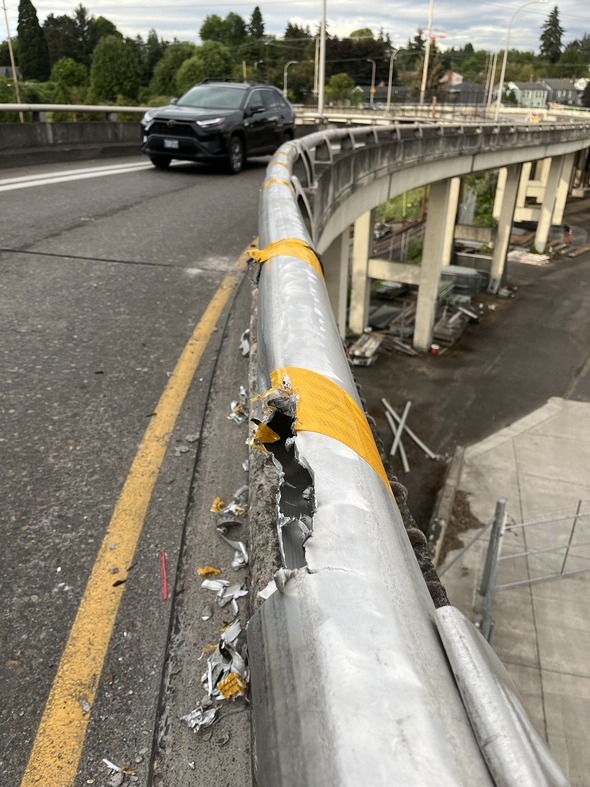 A guardrail on the NE 33rd Avenue bridge has been damaged over the years by long trucks