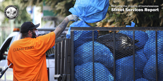 A Clean Start staff member loading trash bags into a truck