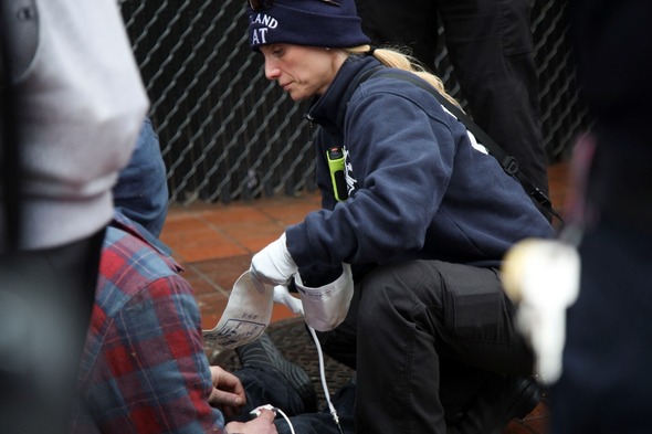 A member of the Fire Bureau's CHAT team addresses the medical needs of someone.