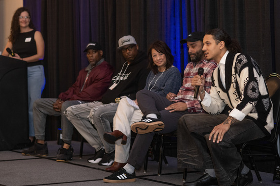 Five panelists on a stage