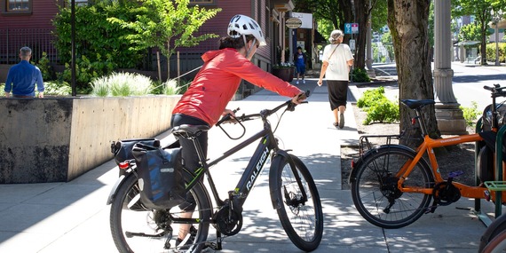 BPS - woman getting on an electric bike with another electric bike parked nearby