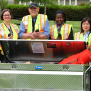 BEECN photo of a group of people in high-visibility safety gear around a large metal box.