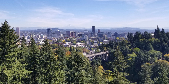 Downtown Portland skyline with Vista Avenue bridge and trees in foreground