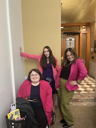 Councilors Koyama Lane, Morillo pose with Cassie Wilson in the D3 office in City Hall, wearing pink blazers.