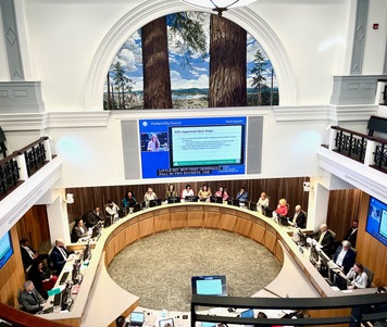 Photo of 17 councilors and commissioners from chambers balcony