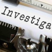 Typewriter typing the word "investigation."