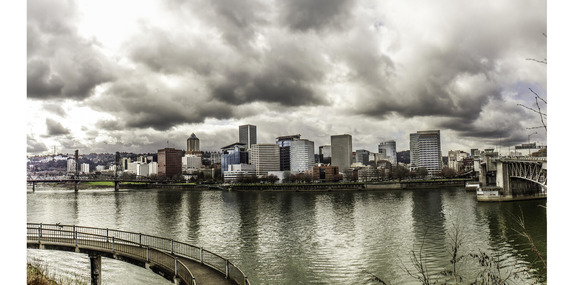 Clouds over downtown Portland with Willamette River in foreground