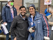 Councilor Kanal stands next to organizer Jamie Partridge at an American Postal Workers Union rally.
