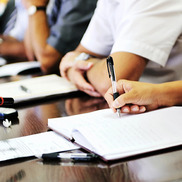 Stock photo of hand writing with pen at a meeting