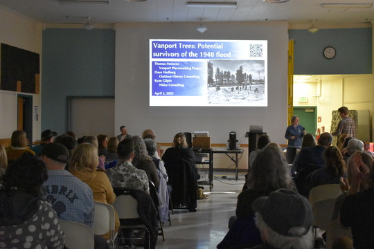 PPR - Group of people looking at a presentation in the front of a room 