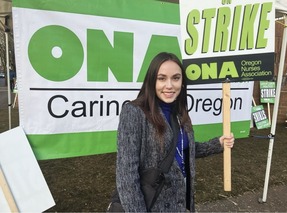 Councilor Morillo at the ONA strike, holding a sign that says "STRIKE: ONA"