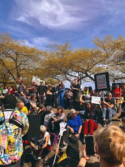 Councilor Morillo speaking in front of a large crowd at the Hands Off rally 