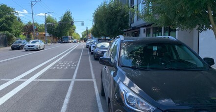 Vehicles parked on the street in front of building