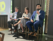 Councilors Sameer Kanal and Tiffany Koyama Lane sit on stage with the moderator at the More Equitable Democracy panel