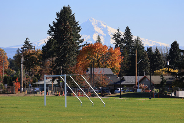 View of Mt Hood and grassy green soccer field at Parklane Park