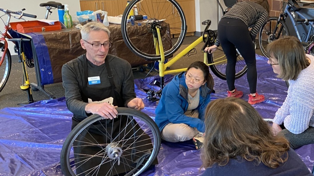 Timo Forsberg helps change a bike tire at a bike fair.