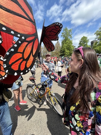 friends in a park holding butterfly signs