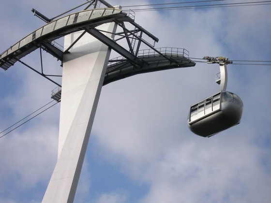A Portland Aerial Tram cabin travels near the lower tram tower