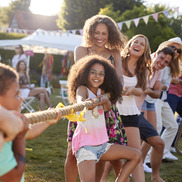 Group diverse in age and race and gender play tug of war - Party on Portland image