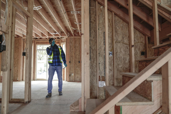 A building inspector walks through a framed up structure