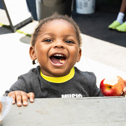 Summer Free For All child eating an apple