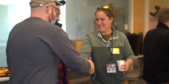 City employee shakes hands with man at public event