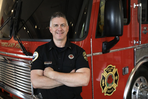 Lieutenant Laurent Picard stands in front a Portland fire truck.