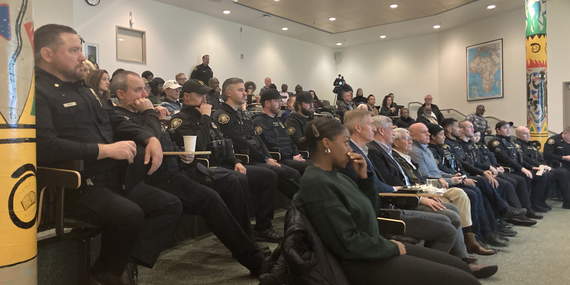 Residents and police officers attend a meeting in the Portland Building.