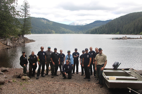 Group of firefighters at Bull Run Watershed and Mt. Hood under a cloud sky