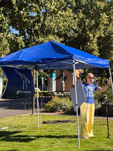 Community member speaks at Stop the Cuts rally