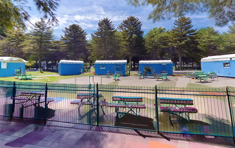 Rendering of the outdoor day center planned for an empty downtown lot near Union Station, showing picnic tables, bathrooms, and showers.