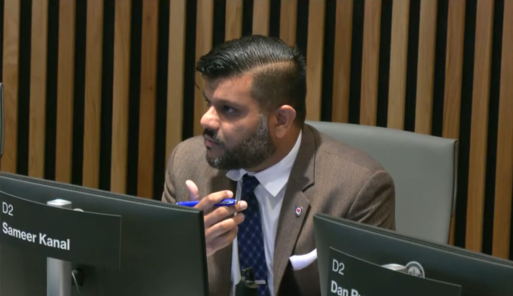 Councilor Kanal asks questions during a council meeting