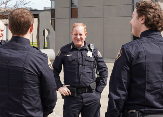 Police Chief Bob Day talking with police officers