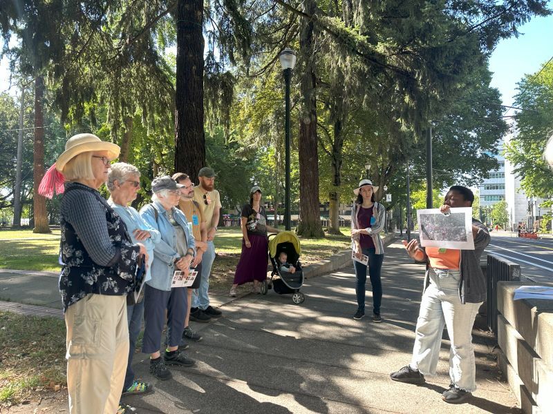 PPR - Group of people listening to talk on sidewalk near park
