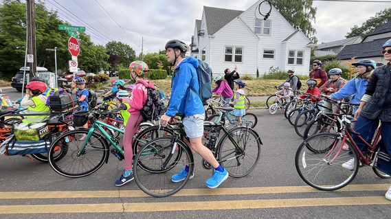 School bike bus shows kids and adults getting ready to ride their bicycles