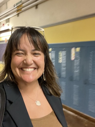 Councilor Koyama Lane smiles in front of lockers