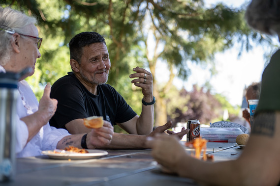 People eat at a table at a hope and bread service