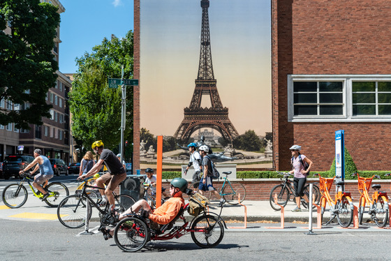 People ride bikes in front of the Portland Art Museum's BIKETOWN bike share station in downtown Portland.