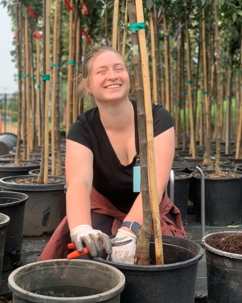 PPR - woman smiling with small potted tree