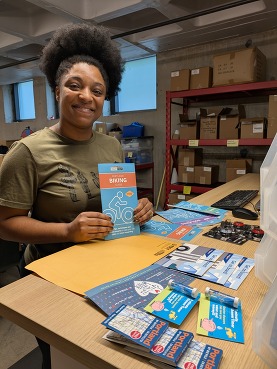 A PBOT employee helps organizes bike resources such as maps, guides, and more to distribute to the public.