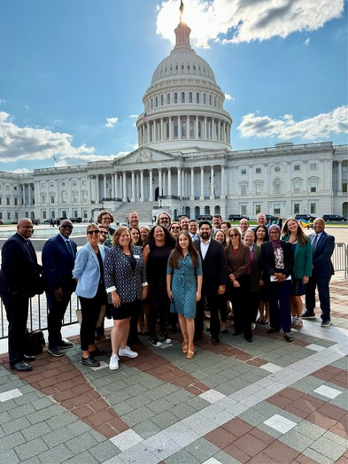 A group of people in front of the US Capitol